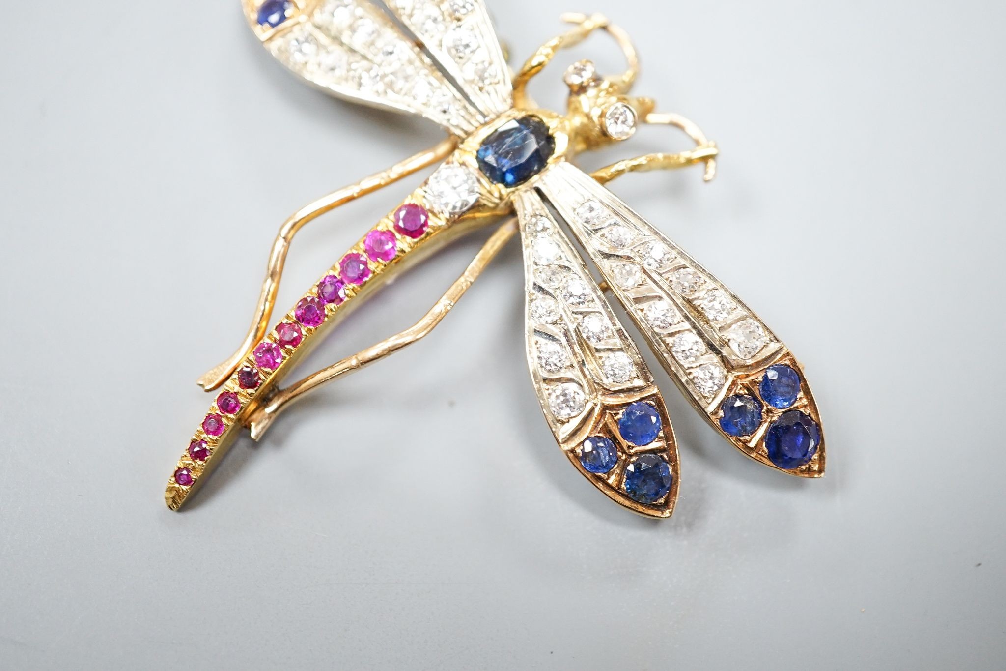 A Victorian style 14k, ruby, sapphire and diamond set dragonfly brooch, 47mm, gross weight 18.5 grams.